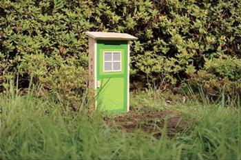 野原に扉のようなポストが建っている写真