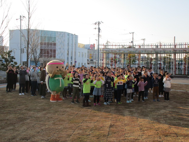 全員で記念撮影をする様子。たくさんの子ども達ととりかめくんがポーズをとっています。